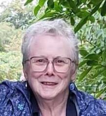 A headshot photo of Amanda standing under a tree